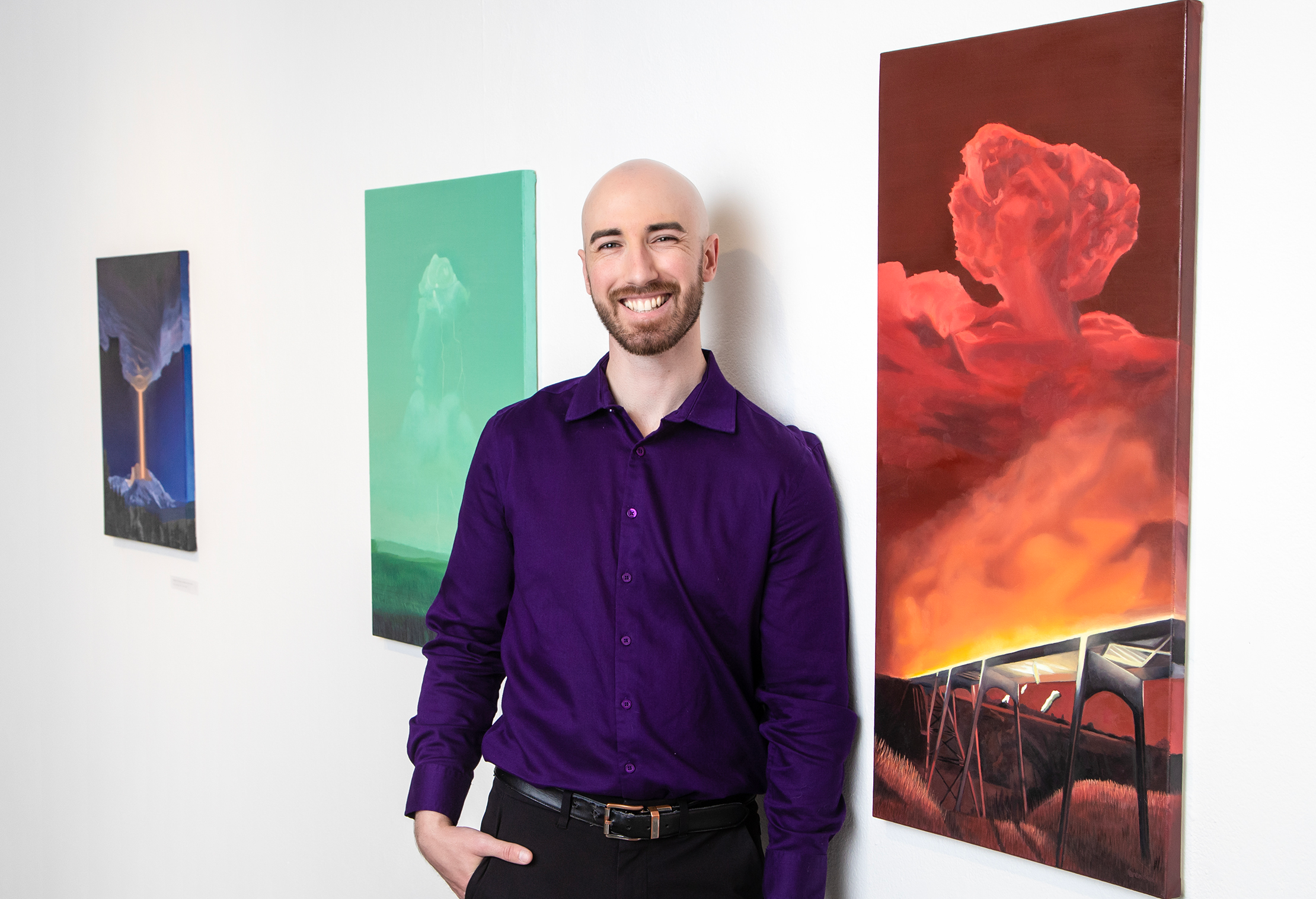 Calgary Artist at gallery showing of his new work. Vibrant paintings showcase his smile