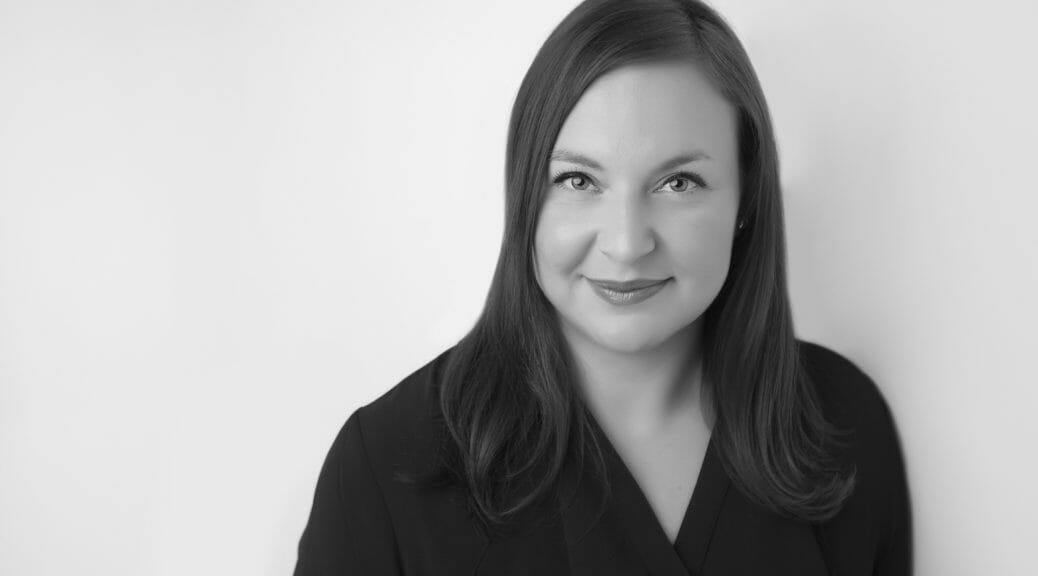 Calgary female professional woman in black and white and dark top smiling slightly for her headshots