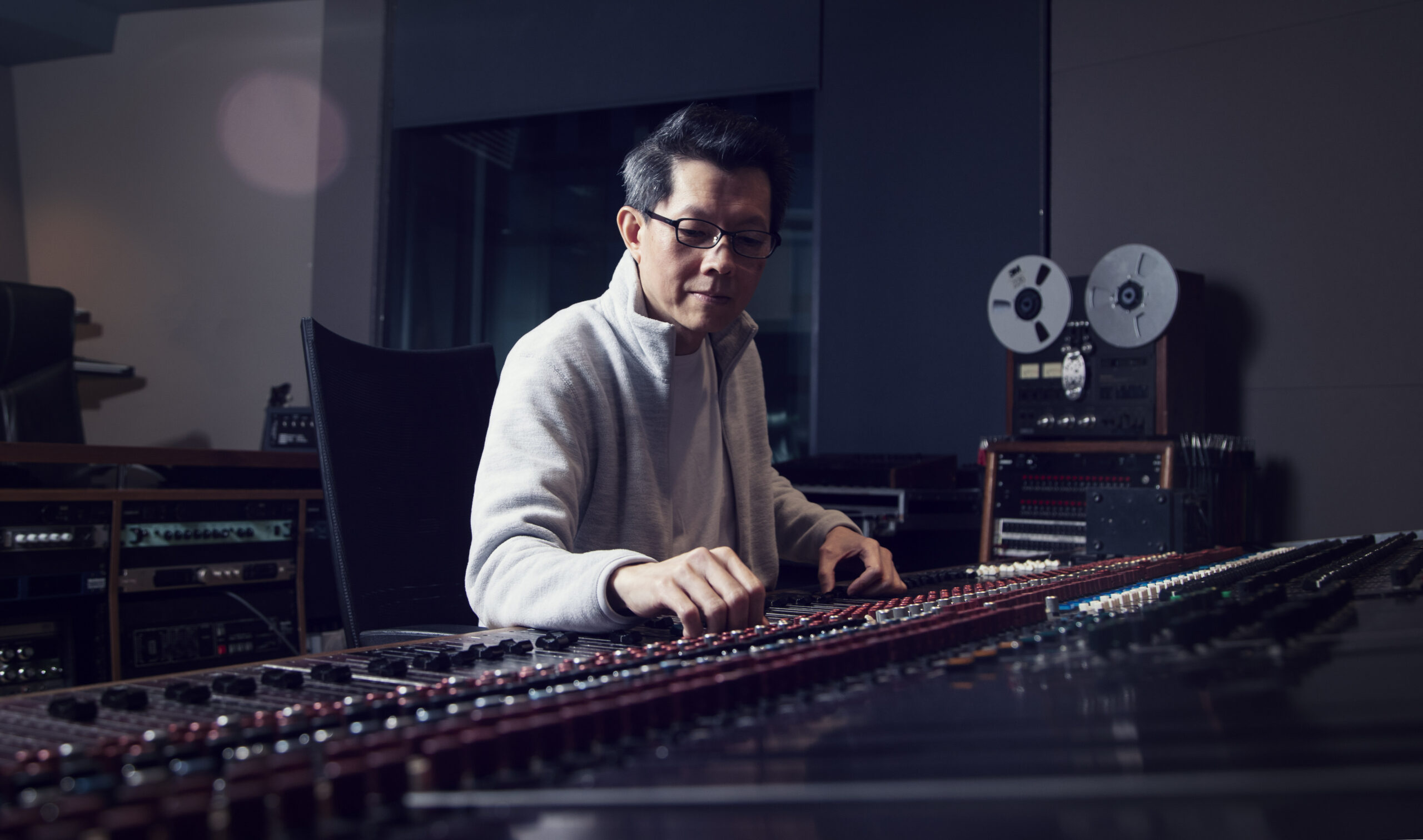 Music producer mixing tunes at the Calgary Bell Center for music in his headshot photography session.