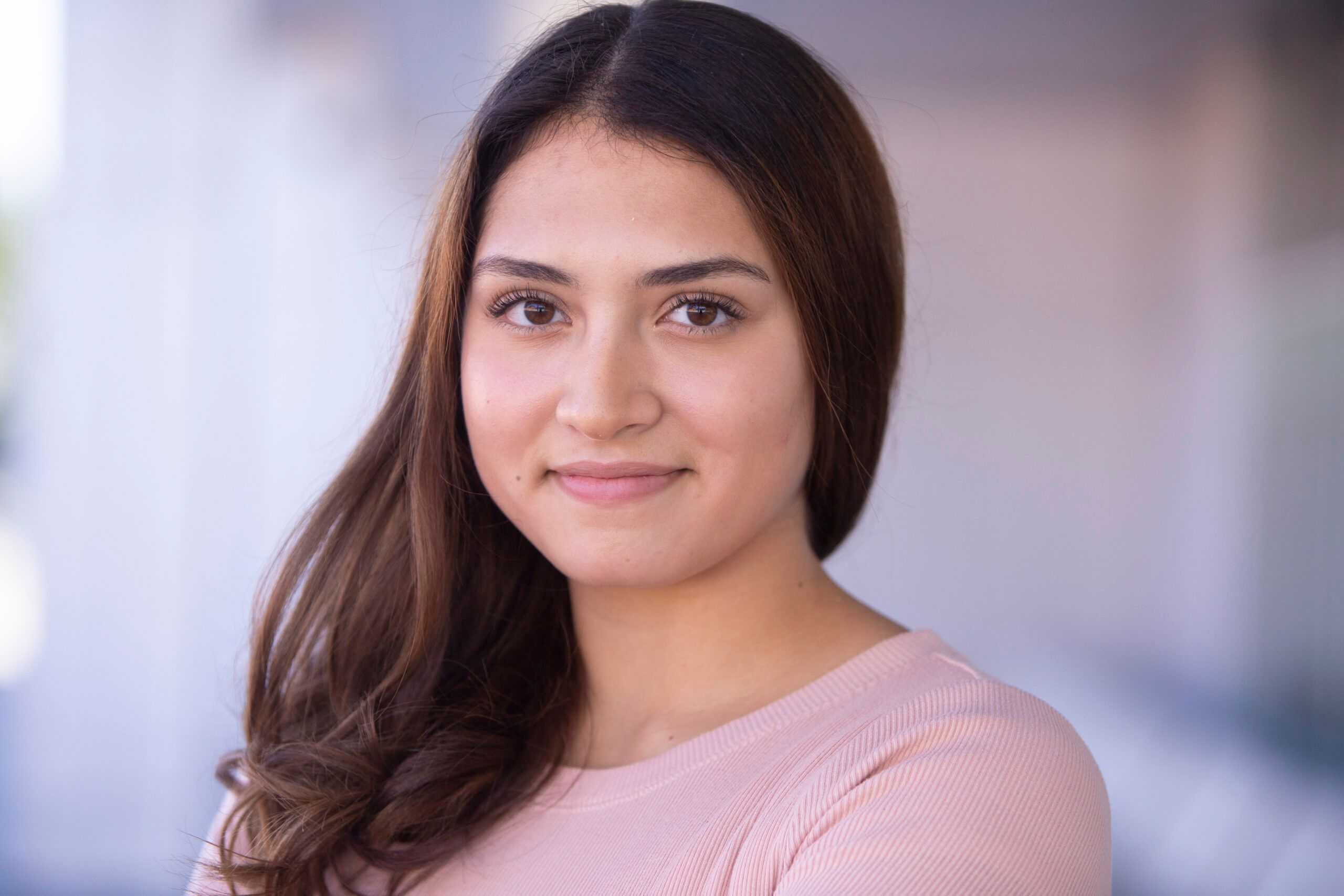 Young actor in Calgary, Alberta wearing pink shirt for headshot photo