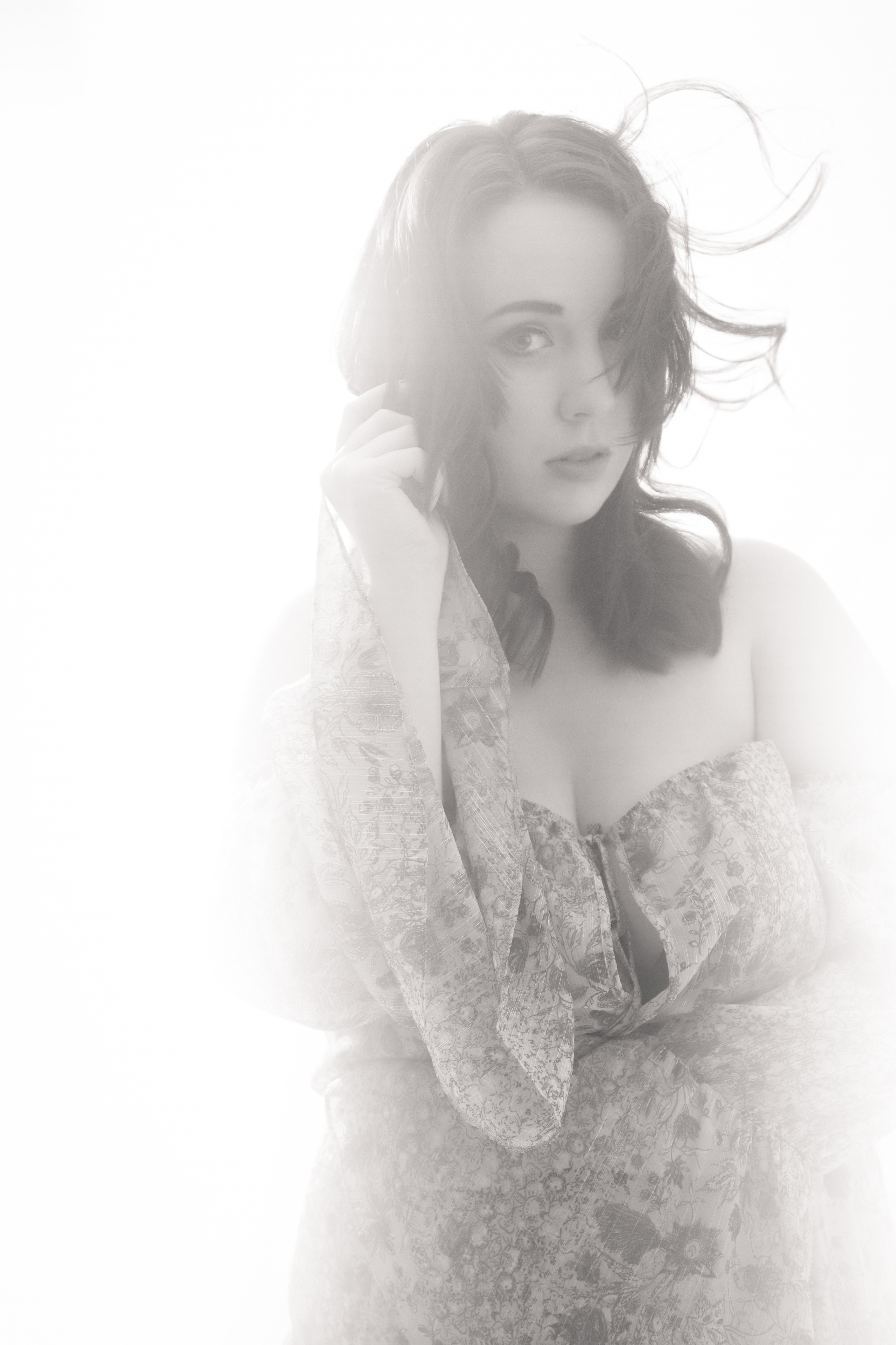 Soft focus, elegant pose, floral dress.